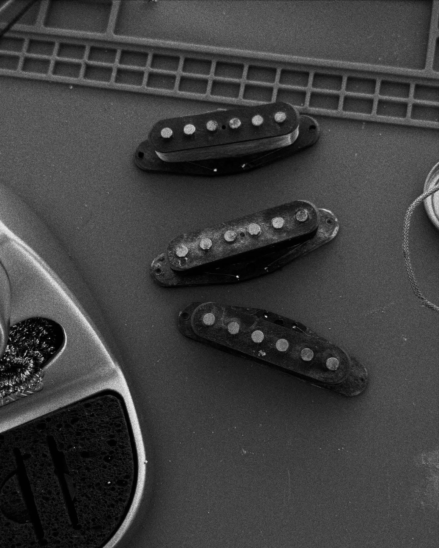 Close-up of pickup sets resting on a guitar body